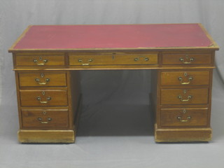 A mahogany kneehole pedestal desk inset tooled leather writing surface above 1 long and 8 short drawers 60"