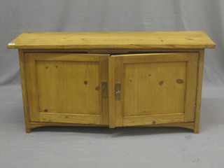 A rectangular pine cupboard enclosed by panelled doors 42"