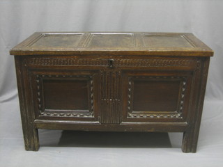 An 18th Century oak coffer of panelled construction with hinged lid, the interior fitted a glove box 42"