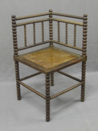 A 19th Century corner chair with bobbin turned decoration