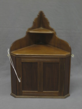 An Edwardian walnut hanging cabinet enclosed by panelled doors 17"