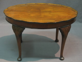 A Georgian style walnut oval occasional table raised on cabriole supports 28"