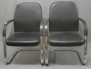A pair of chrome open arm chairs