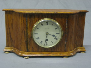 A 1930's 8 day mantel clock with silvered dial and Arabic numerals by Jays of Oxford Street, contained in an oak case