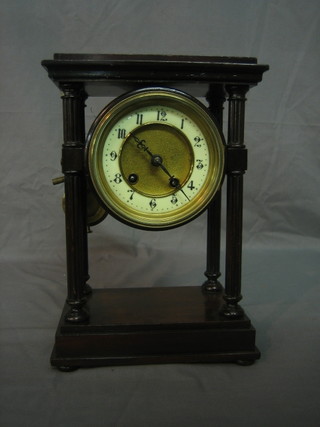 A 19th Century French striking Portico clock with enamelled dial contained in a mahogany case