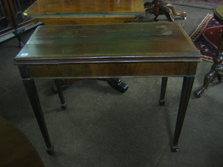 A 19th Century rectangular mahogany tea table with crossbanded top, raised on square supports ending in spade feet 36" (requires some attention)