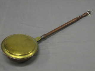 An 18th/19th Century brass warming pan with turned fruit wood handle