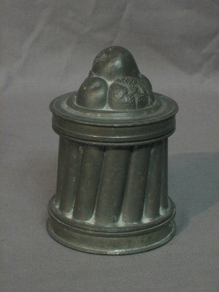 A 19th Century cylindrical pewter jelly mould, with wood decoration 4.5"