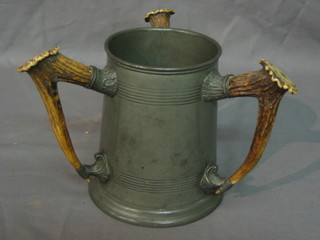 An Edwardian pewter 3 handled loving cup with stag horn handles,inscribed to the front the base marked James Dixon Sheffield 497 Rowell, Oxford 6"