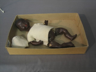 An Armand Marseille black baby doll with open and shutting eyes, open mouth with 2 teeth, the head incised A M Germany 351/2/0X.K