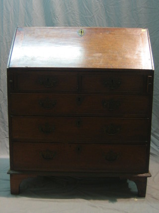 A Georgian mahogany bureau, the fall front revealing a well a fitted interior above 2 short and 3 long drawers, raised on bracket feet 35"