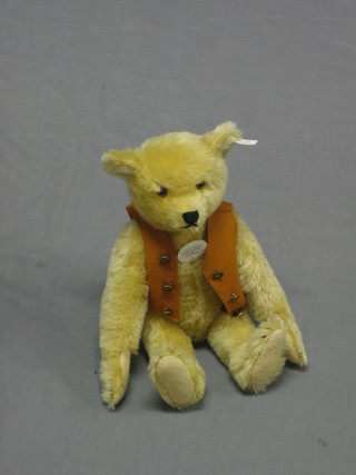 A yellow 1995 Steiff teddy bear with articulated limbs 11" contained in a fabric carrying bag