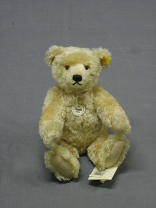 A reproduction 1920's Classic Steiff teddy bear with articulated limbs 13" contained in a cardboard box and with carrier bag