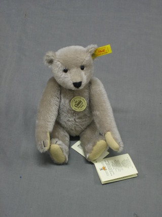 A reproduction 1905 Steiff teddy bear with articulated limbs 9" complete with carrier bag