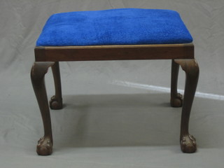 A rectangular mahogany stool with upholstered seat, raised on cabriole ball and claw supports 24"