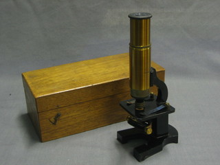 A student's brass and lacquered metal single pillar microscope by Broadhurst Clarkson & Company contained in a mahogany carrying case