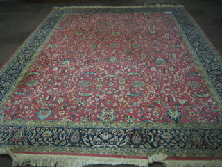 A fine quality Persian red ground and floral patterned carpet with multi row borders 135"x99"