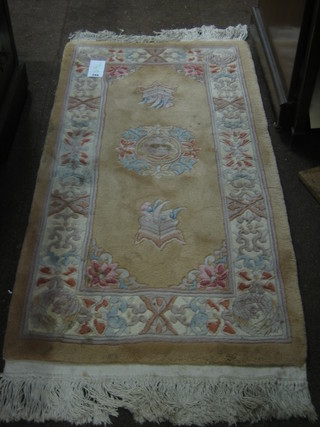 A yellow ground and floral patterned Chinese rug 48" x 45"