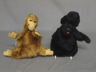 A puppet in the form of a monkey, together with a glove puppet in the form of a black dog