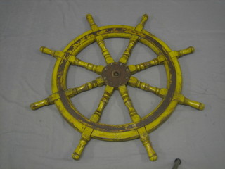 A reproduction wooden and iron 8 spoked ships wheel