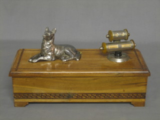 An Art Deco olive wood cigarette box, with decorated lid raised on bracket feet 10"