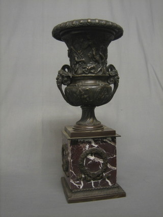 A reproduction bronze urn with classical decoration raised on a square marble base 19"