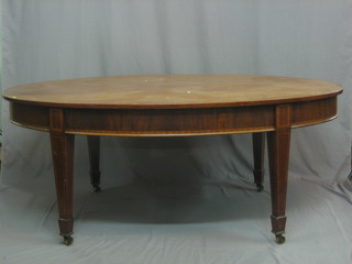 An Edwardian Georgian style oval dining table raised on square tapering supports ending in spade feet 72"