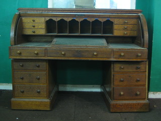 A Victorian carved oak cylinder bureau with well fitted interior, 60" (requires some attention)
