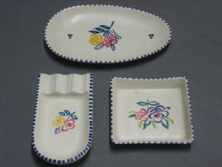 A Poole Pottery arch shaped ashtray 5", a square pin tray 4" and an oval pin tray 7"
