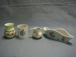 A Poole Pottery jug 3", a shaped Poole Pottery vase 9", a cylindrical Poole Pottery preserve jar 3" and a small Honiton vase (4)
