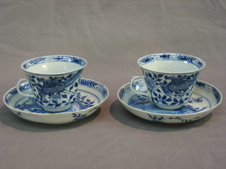 A pair of 18th Century Oriental blue and white cups and saucers the bases with 4 character mark