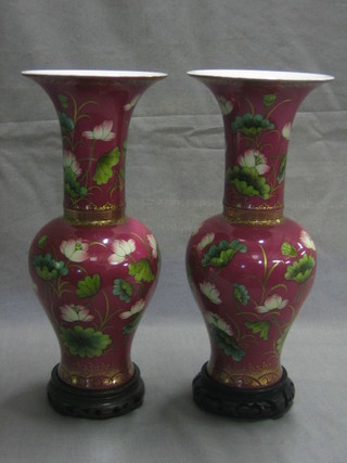 A handsome pair of 18th Century club shaped vases with red ground and floral decoration, the bases with seal marks 11"