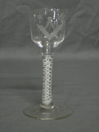 An 18th Century Masonic glass with cotton twist stem, the bowl etched square and compasses, trowel and mull