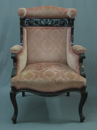 A Victorian mahogany show frame winged armchair with pierced panel decoration, raised on cabriole supports