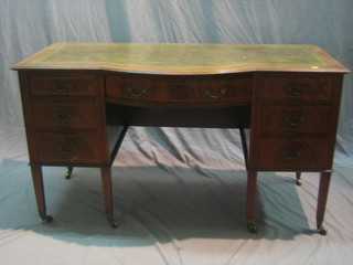 An Edwardian inlaid mahogany bow front writing table fitted 1 long drawer flanked by 6 short drawers, raised on square tapering supports 54"