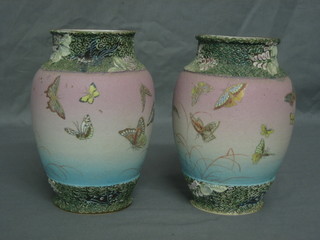 A pair of Oriental porcelain vases decorated butterflies, the base with 3 character mark (chips to base) 7"