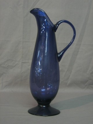 A Bristol blue glass jug raised on a circular spreading foot 15"