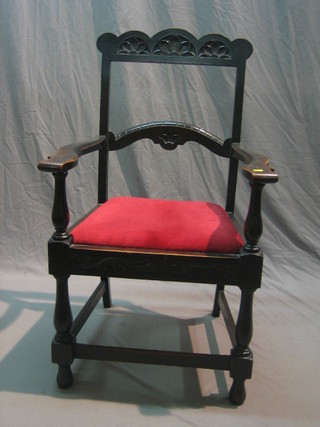 A Victorian carved oak ladder back carver chair