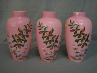 A garniture of 3 19th Century pink glass vases with floral decoration 11" (1 chipped to rim)