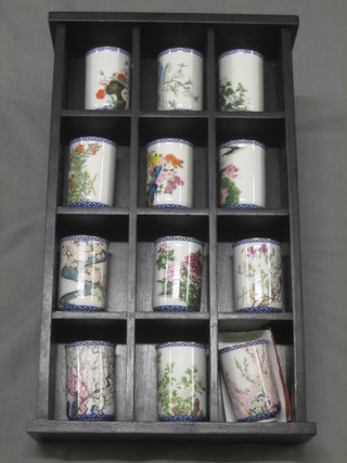 12 Franklin mint tea cups contained in a hardwood stand