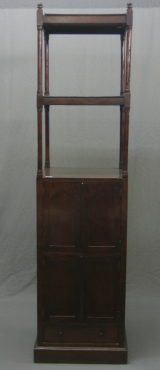 A 19th Century 2 tier mahogany what not on cabinet raised on turned and block supports, the base fitted 2 cupboards enclosed by panelled doors with drawer to the base 18"