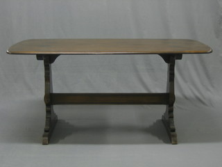 An Ercol dark elm refectory style dining table 60"