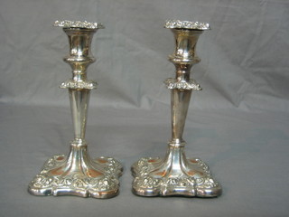 A pair of silver plated candlesticks 8"