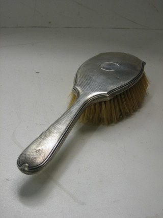 An Art Deco silver backed hairbrush with engine turned decoration