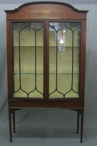 An Edwardian inlaid mahogany display cabinet, the interior fitted shelves enclosed by astragal glazed panelled doors, raised on square tapering supports 39"