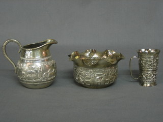 An circular Eastern embossed silver bowl decorated Elephant hunting scenes  and an Eastern silver spirit measure 9ozs