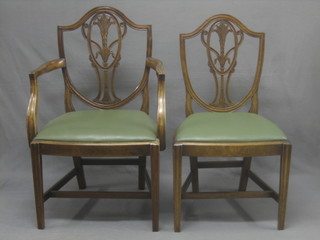 A set of 7 19th Century Hepplewhite style mahogany shield back dining chairs, with vase shaped slat backs with upholstered drop in seats raised on square tapered supports (1 carver, 6 standard)