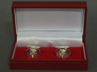A pair of silver cufflinks decorated foxes mask, marked February 19th 2005, cased