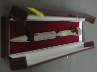 A modern silver double bladed paper knife, cased