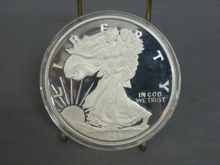A 1986 American silver proof medallion, marked One Half Pound of Fine Silver 999, 8ozs